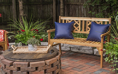 Two blue pillow on a patio bench.