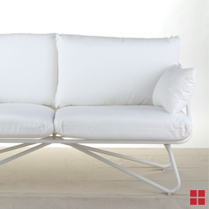 Cushioned white bench with white metal legs. 