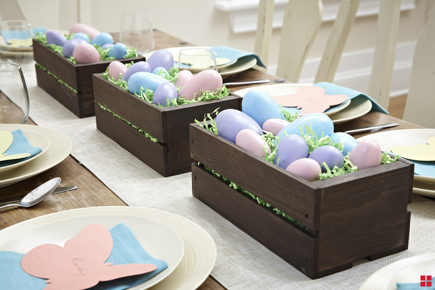 Wooden crate filled with colorfully painted decorative eggs.