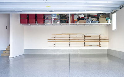 A garage with a shiny gray floor and black and white speckles.