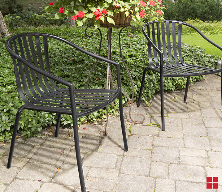 Two unpainted brown metal chairs. 