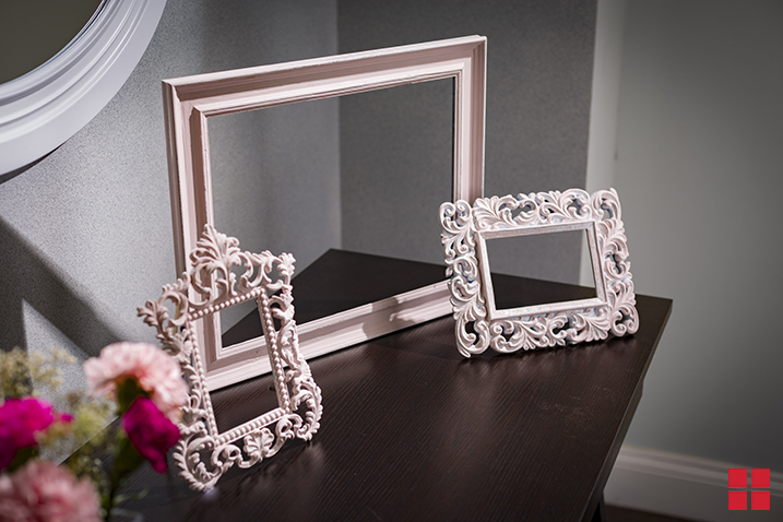 Three pale pink picture frames.