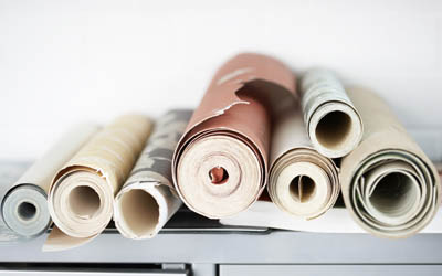 Wallpaper rolls sitting on a table