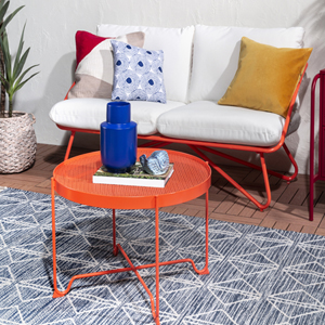 Orange patio table and cushioned bench with orange metal legs.