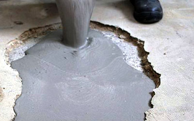 Pouring concrete mix into a hole