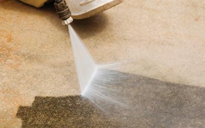 Pressure washing dirt off of a concrete surface