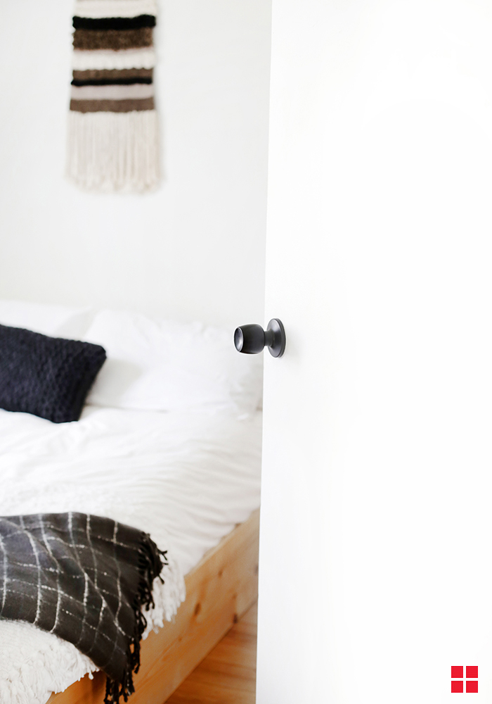 Black door knob on a white bedroom door.