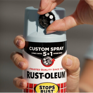 Hand holding a can of Rust-Oleum Stops Rust With Custom Spray 5-in-1